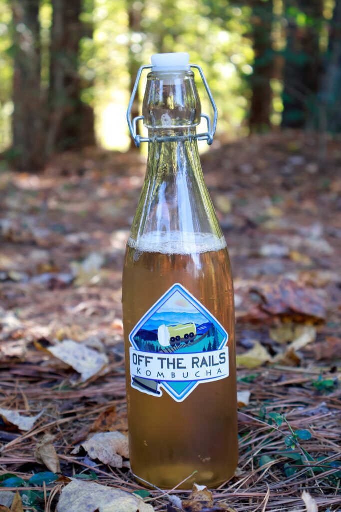 An image of our kombucha on a wooded trail, and we are focusing on how natural and healthy our kombucha is.